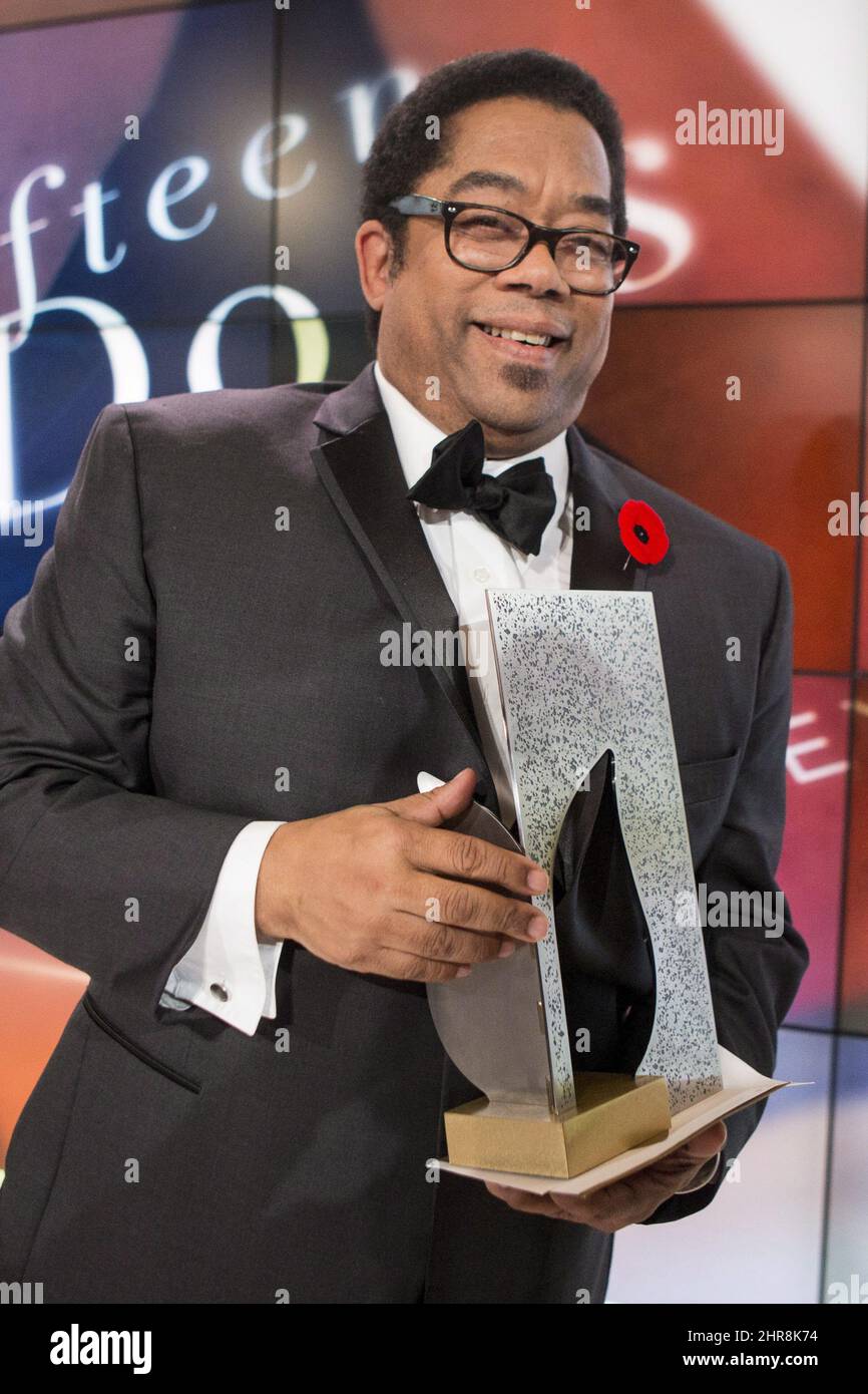 Andre Alexis stands on stage after winning the Giller Prize